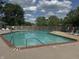 Outdoor swimming pool with lounge chairs and a safety fence on a sunny day at 9458 Fordham St, Indianapolis, IN 46268