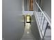 Staircase showcasing a clear shot to the front door and green lawn at 9458 Fordham St, Indianapolis, IN 46268