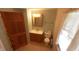 Modest bathroom featuring a wood vanity, toilet, and mirror in a compact space at 980 W Poplar St, Zionsville, IN 46077
