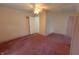 Bedroom featuring pink carpet, ceiling fan, and wallpaper, offering a distinctive look at 980 W Poplar St, Zionsville, IN 46077