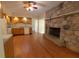 Bright kitchen with wood floors, stone fireplace and modern appliances at 980 W Poplar St, Zionsville, IN 46077