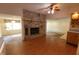 Inviting living room featuring a stone fireplace, wood floors, and an open layout at 980 W Poplar St, Zionsville, IN 46077