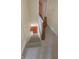 Carpeted staircase with white railings and a detailed wood post leading downstairs at 980 W Poplar St, Zionsville, IN 46077