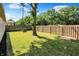 This backyard features a sturdy wood fence, a mature tree, and a well-maintained lawn at 9936 Waterside Dr, Noblesville, IN 46060