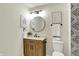 Stylish half-bathroom features a modern vanity with a round mirror and decorative tile accent wall at 9936 Waterside Dr, Noblesville, IN 46060