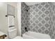 Chic bathroom showcasing patterned tile in the shower and sleek fixtures at 9936 Waterside Dr, Noblesville, IN 46060