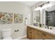 Well-lit bathroom offers double sinks, attractive wooden cabinetry, and black hardware at 9936 Waterside Dr, Noblesville, IN 46060