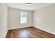 Bright bedroom featuring neutral walls, wood-look laminate flooring, and a sunny window at 9936 Waterside Dr, Noblesville, IN 46060