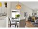 Cozy dining area with a glass-top table, modern chandelier, and sliding glass doors to outdoor deck at 9936 Waterside Dr, Noblesville, IN 46060