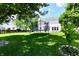 Expansive green backyard featuring a trampoline and swing set, ideal for Gathering fun at 10539 Ross Xing, Fishers, IN 46038