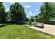 Spacious backyard featuring a trampoline, playground, concrete patio and a beautiful lawn at 10539 Ross Xing, Fishers, IN 46038