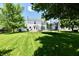 Large backyard with well-maintained lawn, patio with pergola, and trampoline at 10539 Ross Xing, Fishers, IN 46038