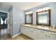 Bright bathroom with double vanity, granite countertop, tile floor and wood framed mirrors at 10539 Ross Xing, Fishers, IN 46038