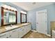Bright bathroom with double vanity, granite countertop, tile floor and wood framed mirrors at 10539 Ross Xing, Fishers, IN 46038