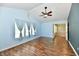 Spacious bedroom featuring vaulted ceilings, hardwood floors, and three large windows at 10539 Ross Xing, Fishers, IN 46038