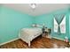 Bedroom with aqua colored walls, wood floors and bed with decorative pillows at 10539 Ross Xing, Fishers, IN 46038
