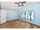 Spacious bedroom with vaulted ceilings, hardwood floors, and three large windows at 10539 Ross Xing, Fishers, IN 46038