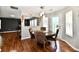 Charming dining room with wood floors, a round table with seating, and decorative wall art at 10539 Ross Xing, Fishers, IN 46038