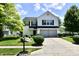 Charming two-story home with a well-manicured lawn and mature trees at 10539 Ross Xing, Fishers, IN 46038