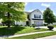 Charming two-story home with a well-manicured lawn and mature trees at 10539 Ross Xing, Fishers, IN 46038