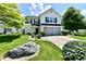Charming two-story home with a well-manicured lawn and mature trees at 10539 Ross Xing, Fishers, IN 46038