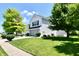 A charming two-story home with a well-manicured lawn and mature trees at 10539 Ross Xing, Fishers, IN 46038