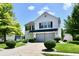 Charming two-story home with a well-manicured lawn and mature trees at 10539 Ross Xing, Fishers, IN 46038