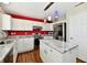 Bright kitchen features white cabinets, granite countertops, stainless steel appliances, and hardwood floors at 10539 Ross Xing, Fishers, IN 46038