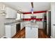 Bright kitchen with white cabinets, granite countertops, stainless steel appliances, and island at 10539 Ross Xing, Fishers, IN 46038