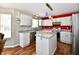 Bright kitchen with white cabinets, granite countertops, stainless steel appliances, and island at 10539 Ross Xing, Fishers, IN 46038
