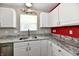 Kitchen featuring granite countertops, stainless steel dishwasher, updated hardware, and lots of natural light at 10539 Ross Xing, Fishers, IN 46038