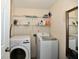 Bright laundry room with mirror, shelving and modern washer and dryer at 10539 Ross Xing, Fishers, IN 46038