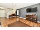 Bright living room features hardwood floors, an antique desk, and stairs leading to the second floor at 10539 Ross Xing, Fishers, IN 46038