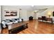 Inviting living room featuring hardwood floors, comfortable sofa, kitchen view, and stairs at 10539 Ross Xing, Fishers, IN 46038