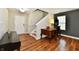 Open living room featuring hardwood floors, staircase, and lots of natural light at 10539 Ross Xing, Fishers, IN 46038