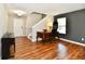 Spacious living room features hardwood floors, staircase, and lots of natural light at 10539 Ross Xing, Fishers, IN 46038