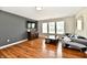Living room with hardwood floors, tv, modern furniture and lots of natural light at 10539 Ross Xing, Fishers, IN 46038