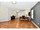 Bright living room with hardwood floors, an antique wood desk, piano, and an decorative anchor at 10539 Ross Xing, Fishers, IN 46038