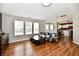 Bright living room featuring hardwood floors, a comfortable sofa, and an open view to the kitchen at 10539 Ross Xing, Fishers, IN 46038