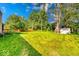 An expansive backyard with lush greenery and mature trees features a shed for outdoor storage at 11 N Restin Rd, Greenwood, IN 46142