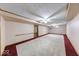 Basement with neutral carpet, white walls, ceiling fans, and updated lighting, including a window at 11 N Restin Rd, Greenwood, IN 46142