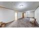 Large basement space featuring updated lighting, neutral carpet, and doorways to other rooms at 11 N Restin Rd, Greenwood, IN 46142