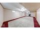 Spacious basement with neutral carpet, updated lighting, a couple of windows, and white walls at 11 N Restin Rd, Greenwood, IN 46142