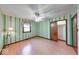 Striking bedroom features striped wallpaper, wood-look floors, and closet at 11 N Restin Rd, Greenwood, IN 46142