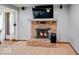 Close up of brick fireplace with a mounted TV, and glass doors at 11 N Restin Rd, Greenwood, IN 46142