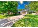 Charming ranch home with a spacious front yard, large tree, and an attached two-car garage at 11 N Restin Rd, Greenwood, IN 46142