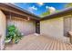 Welcoming front porch featuring wood flooring, potted plants, and a brick exterior at 11 N Restin Rd, Greenwood, IN 46142