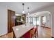 Kitchen features wooden cabinets, granite countertops, a center island and hardwood floors at 11 N Restin Rd, Greenwood, IN 46142