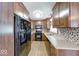 Modern kitchen featuring wooden cabinets, a gas range, stainless steel appliances, and backsplash at 11 N Restin Rd, Greenwood, IN 46142