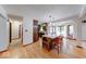 Bright kitchen featuring an island with seating, wooden cabinets, and hardwood floors at 11 N Restin Rd, Greenwood, IN 46142